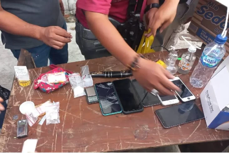 Kapolres Metro Tangerang Kota Kombes Raden Muhammad Jauhari menunjukkan barang bukti sabu dan telepon genggam milik tersangka A dalam konferensi pers pengungkapan kasus narkotika Jatiuwung pada 20 Januari 2026.