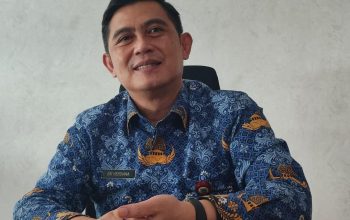 Petugas loket Bapenda Tangsel sedang melayani warga yang mengajukan berkas keringanan pajak daerah.